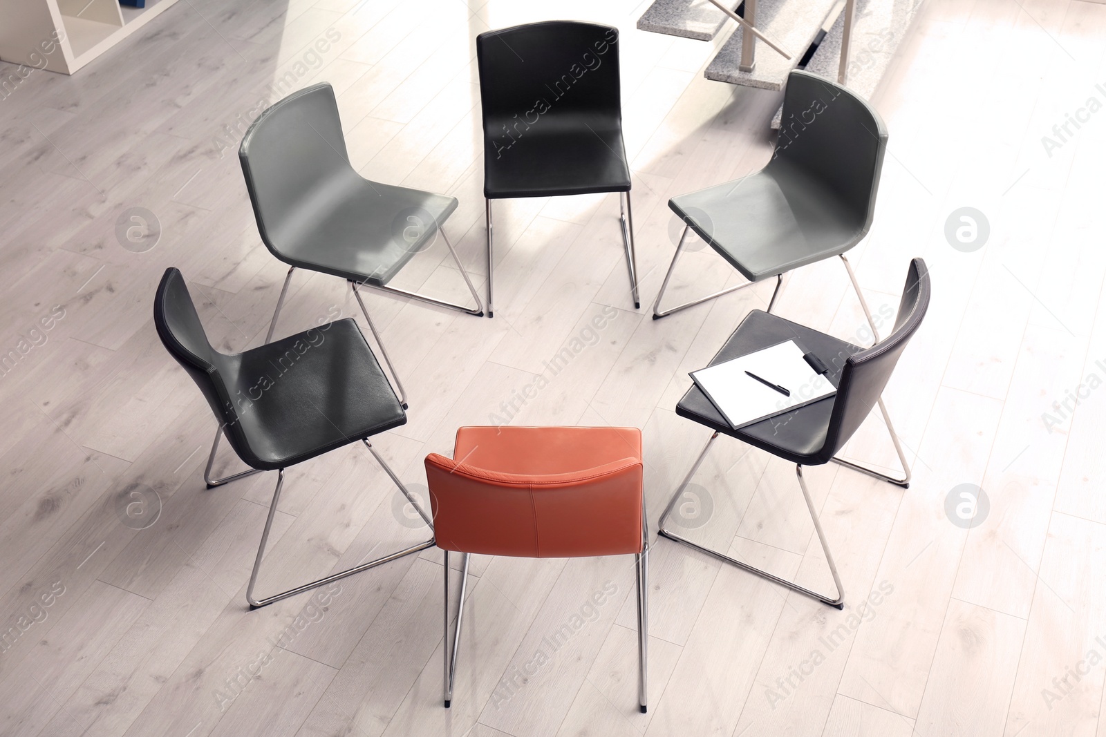 Photo of Chairs prepared for group therapy session in office. Meeting room interior