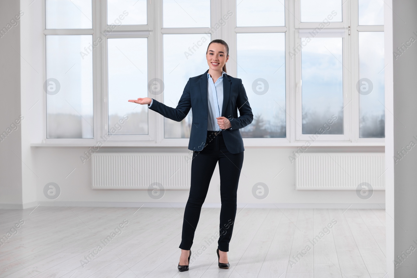 Photo of Happy real estate agent showing new apartment