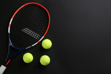 Tennis racket and balls on black background, flat lay. Space for text