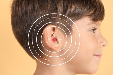 Image of Cute little boy with hearing problem on color background, closeup