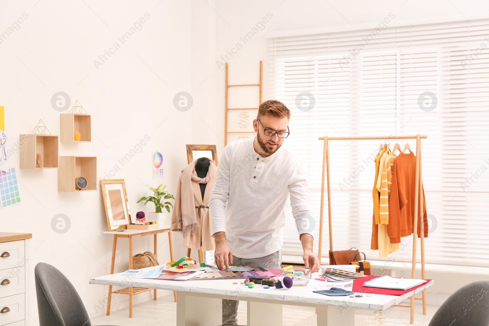 Photo of Fashion designer creating new clothes in studio