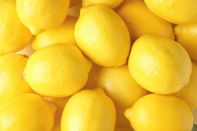 Photo of Many fresh ripe lemons as background