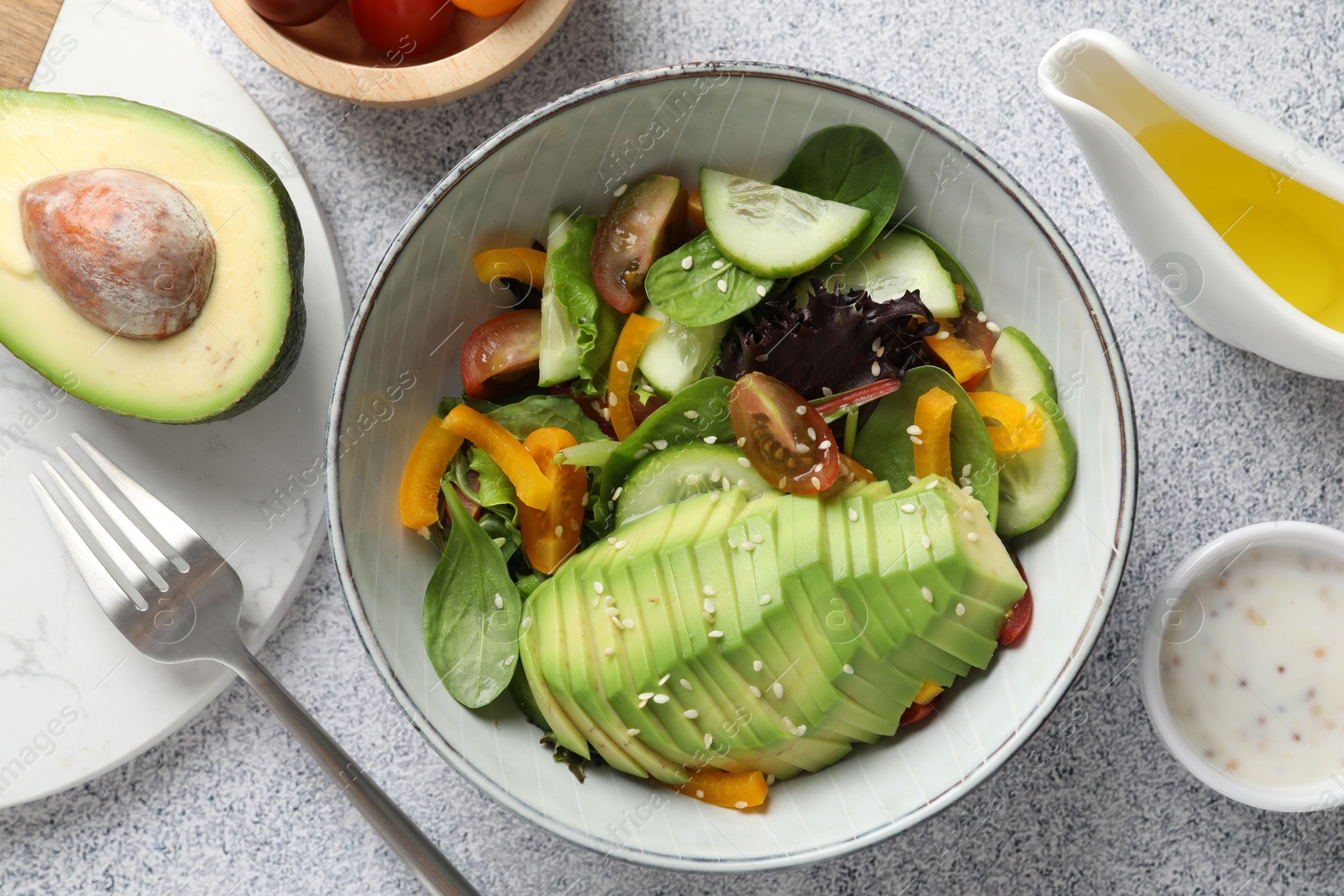 Photo of Healthy dish high in vegetable fats served on light textured table, flat lay