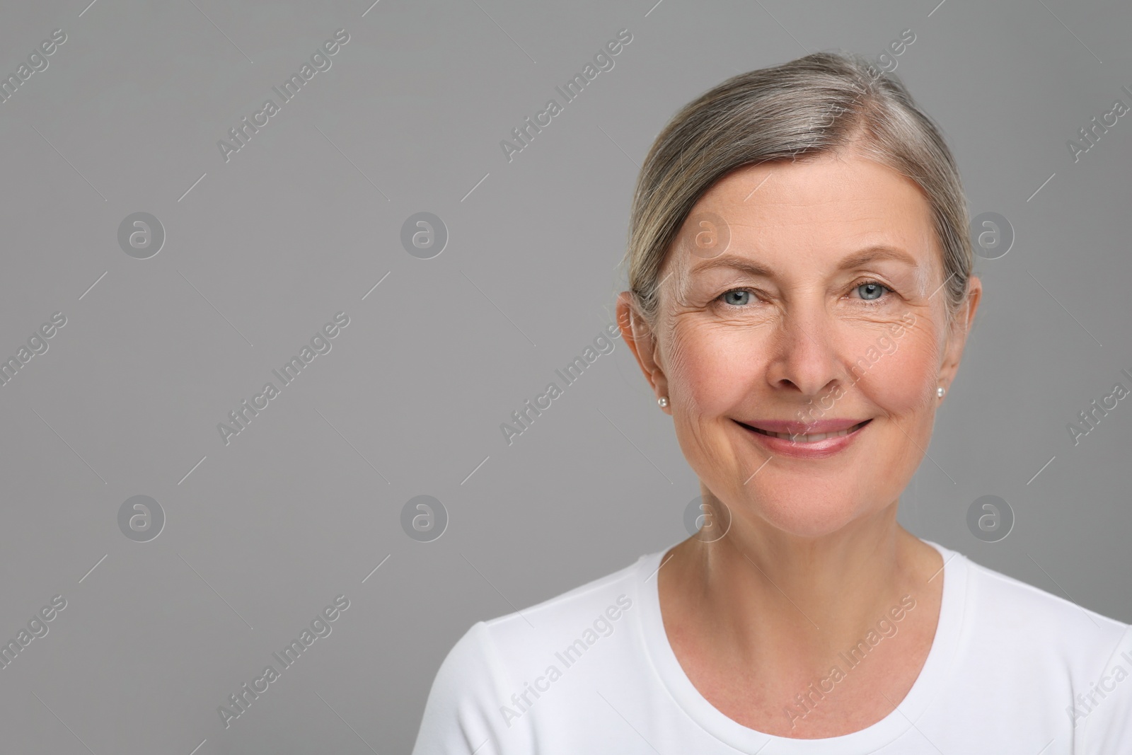 Photo of Portrait of senior woman with aging skin on grey background, space for text. Rejuvenation treatment