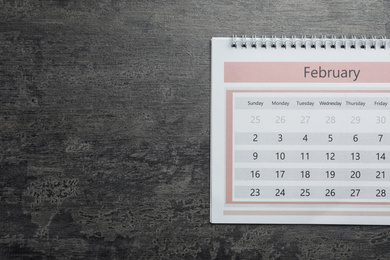 Photo of February calendar on grey stone background, top view. Space for text