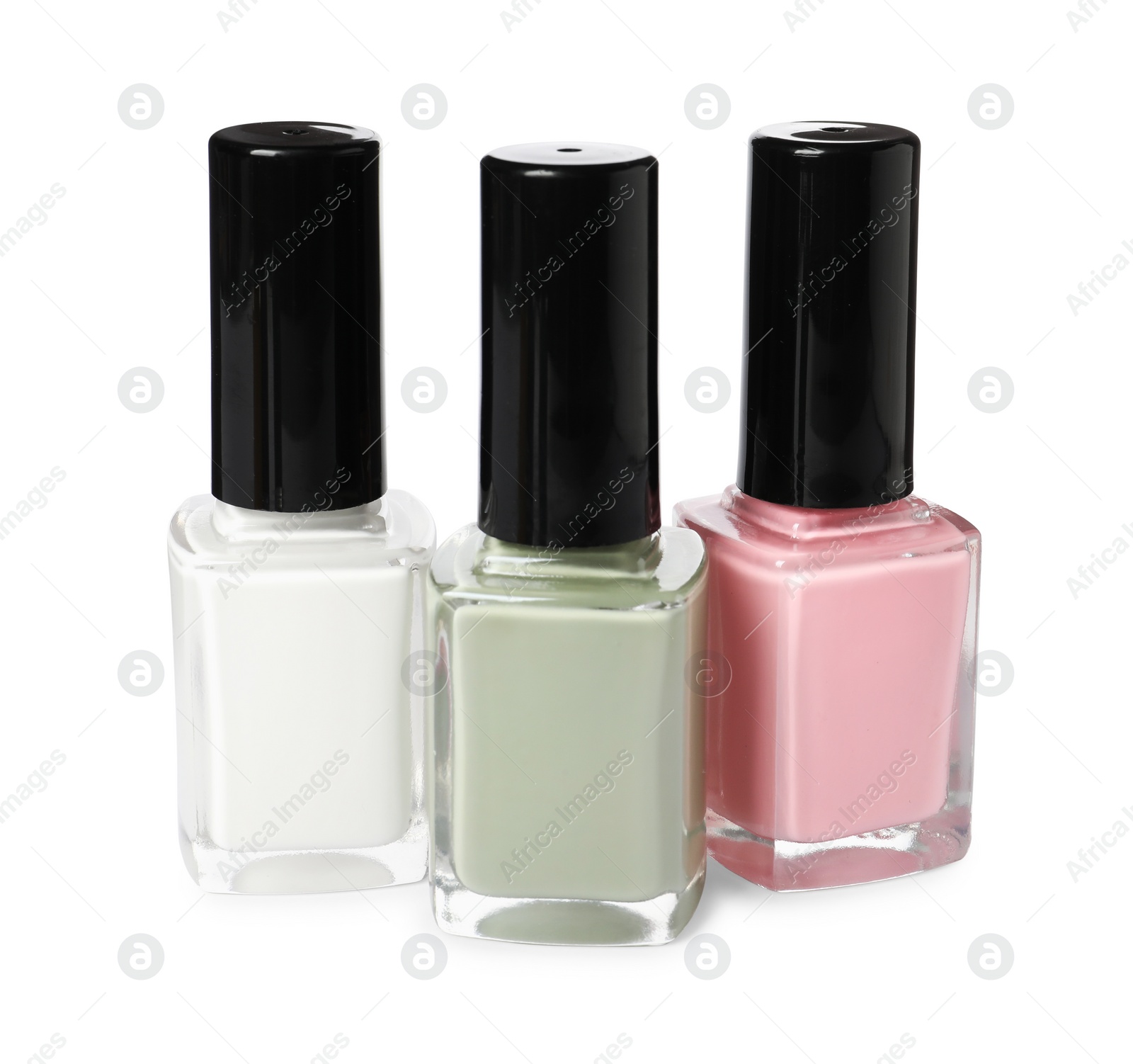 Photo of Pastel nail polishes in bottles isolated on white