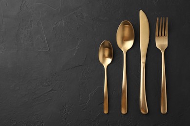 Photo of Beautiful cutlery set on black table, flat lay. Space for text