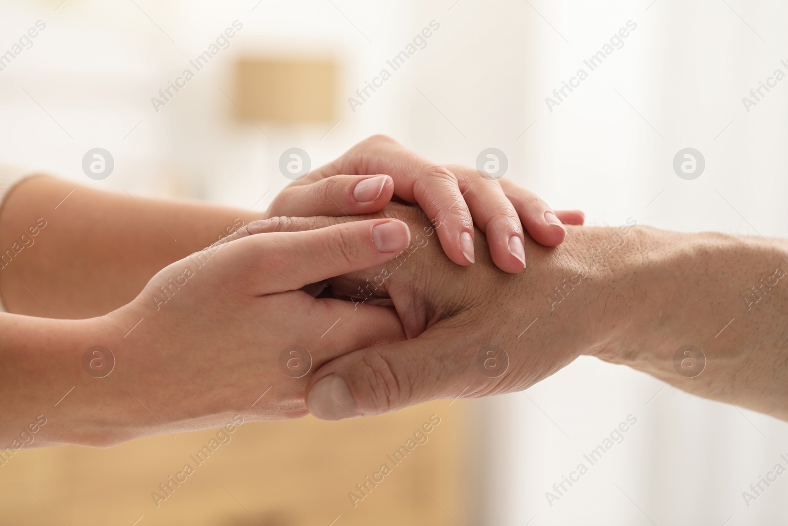 Photo of Trust and deal. Man with woman joining hands indoors, closeup