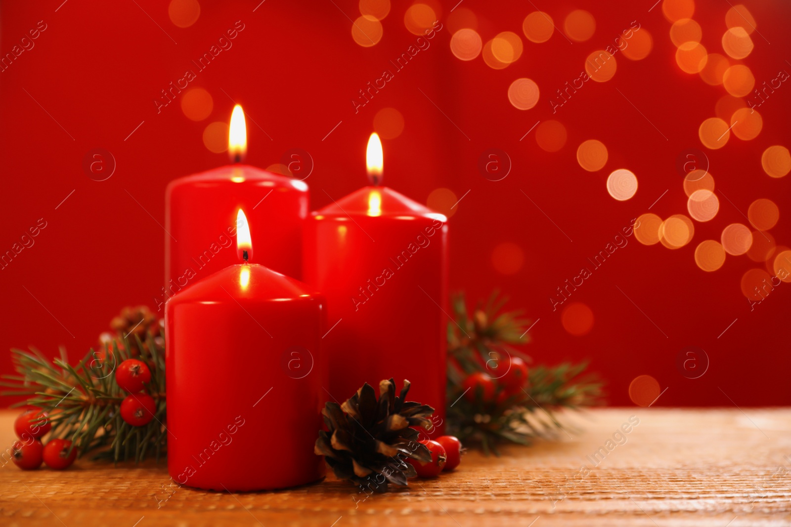 Photo of Beautiful Christmas composition with burning candles on wooden table against blurred lights. Space for text