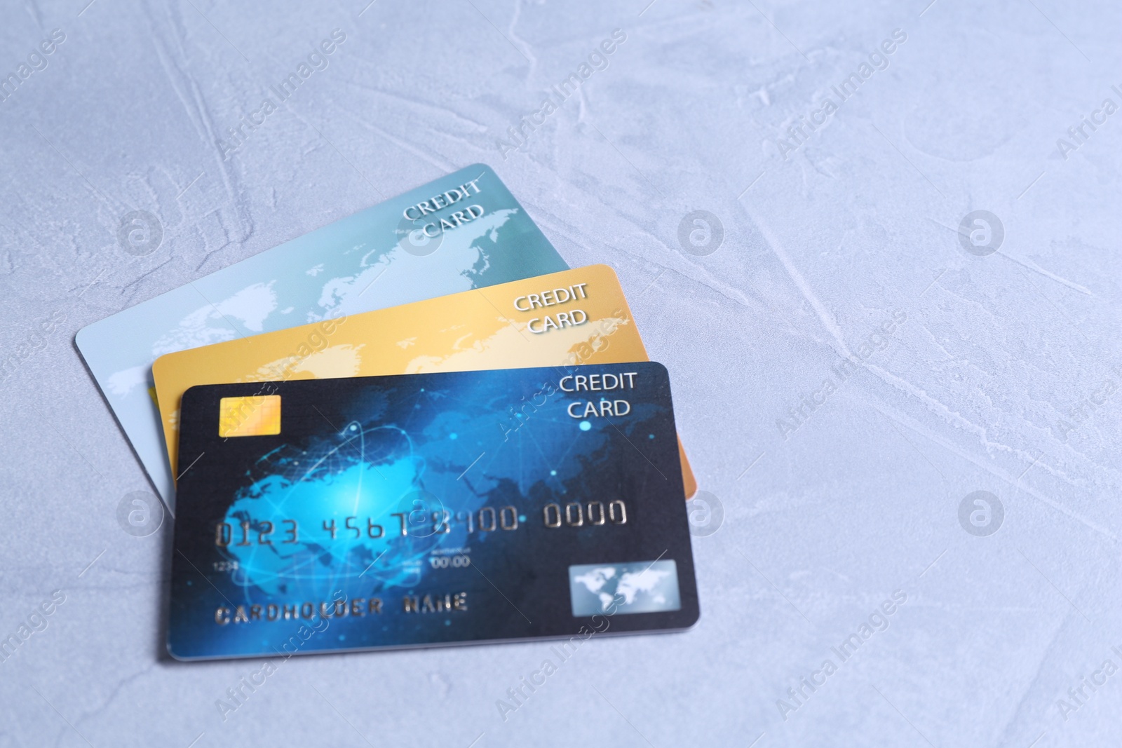 Photo of Credit cards on grey textured table, space for text
