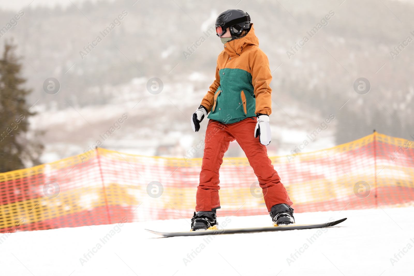 Photo of Snowboarder on slope at resort. Winter vacation