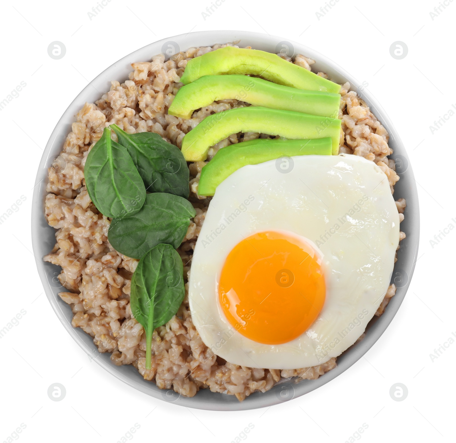 Photo of Tasty boiled oatmeal with fried egg, avocado and basil isolated on white, top view