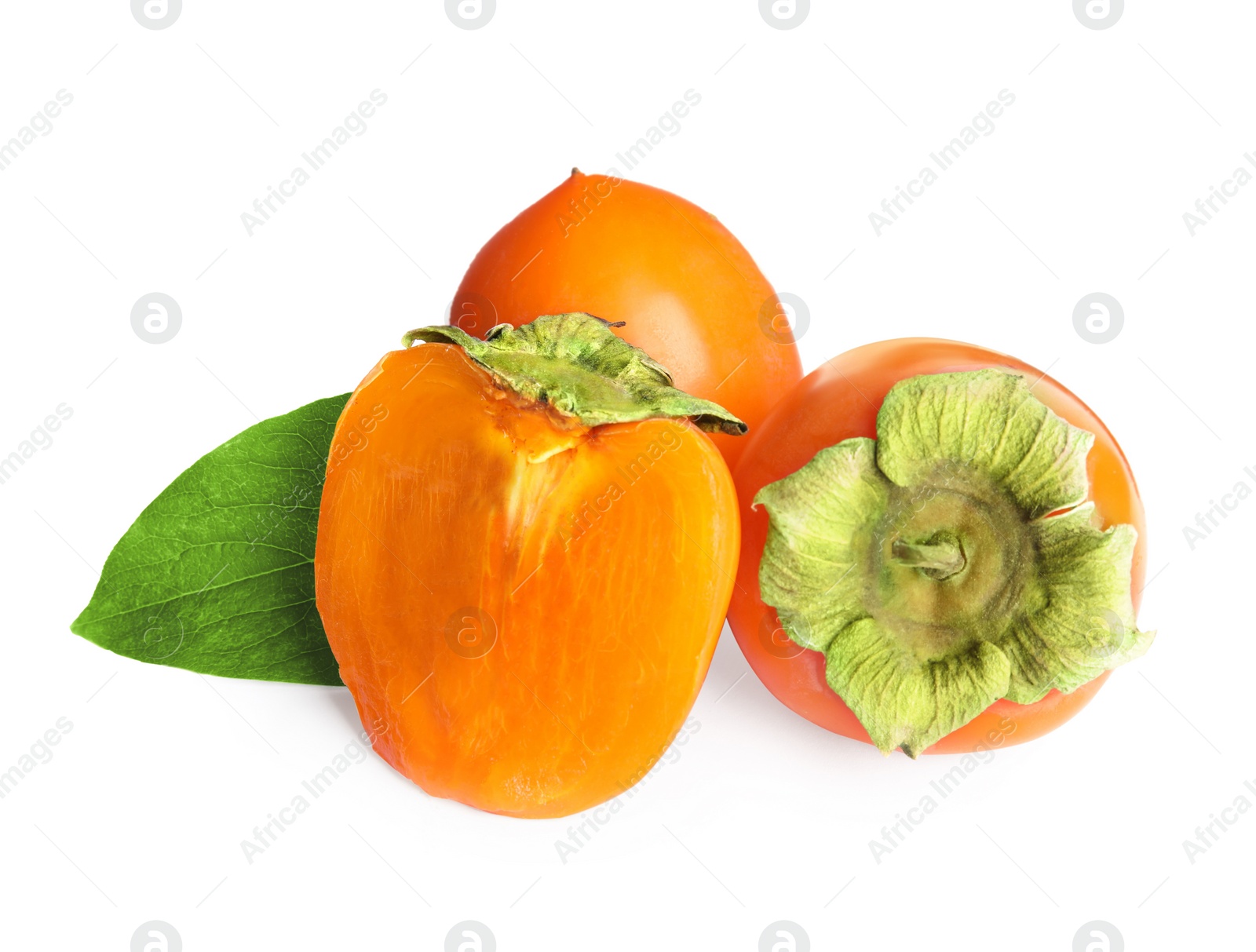 Photo of Delicious cut and whole persimmons isolated on white