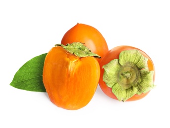 Photo of Delicious cut and whole persimmons isolated on white