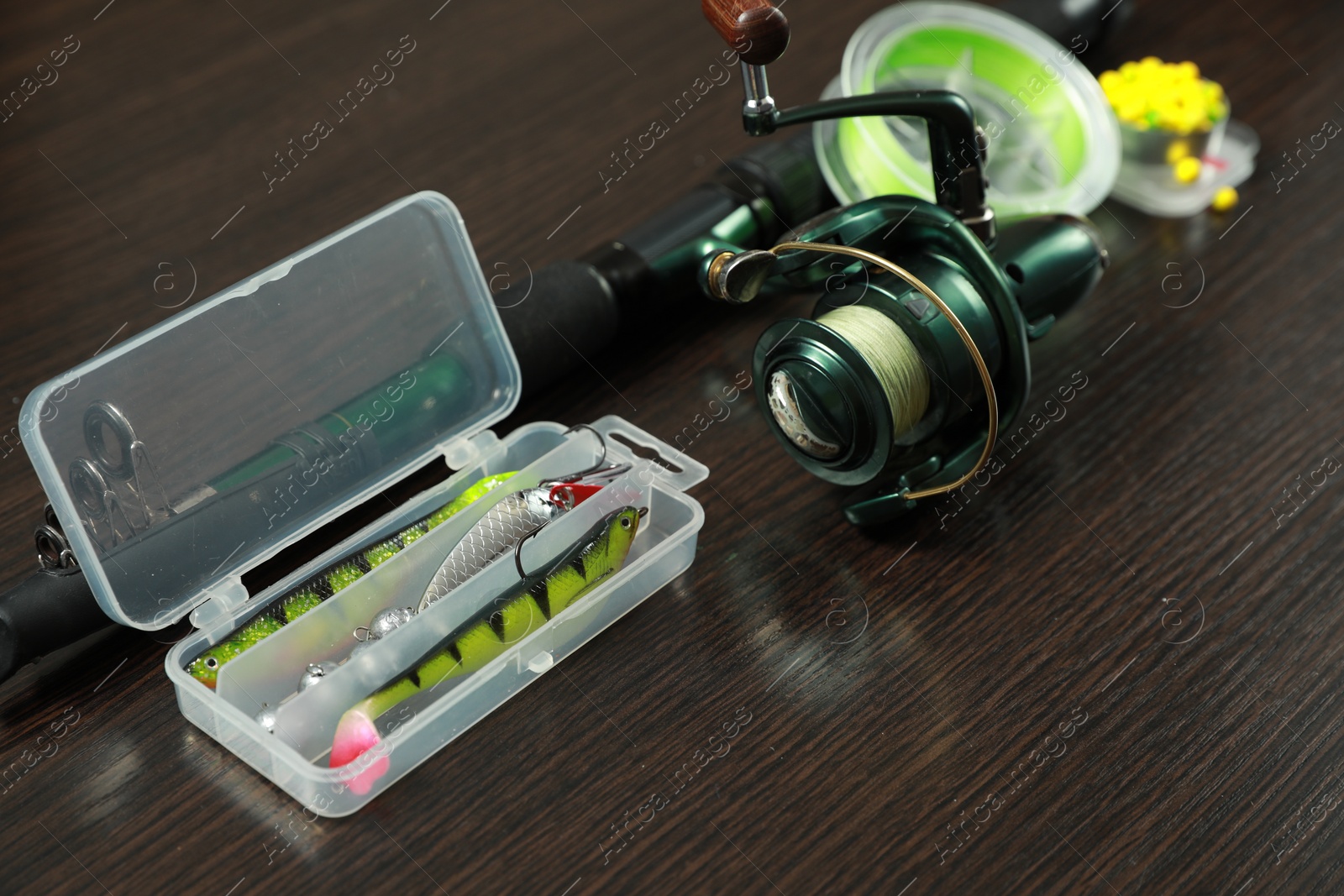 Photo of Fishing tackle on dark wooden background, closeup