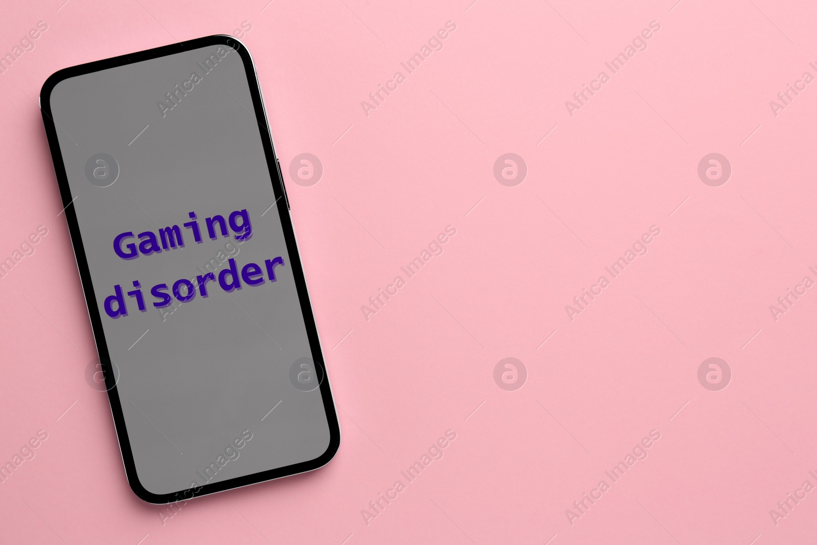 Photo of Smartphone with phrase Gaming Disorder on pink background, top view and space for text. Addictive behavior