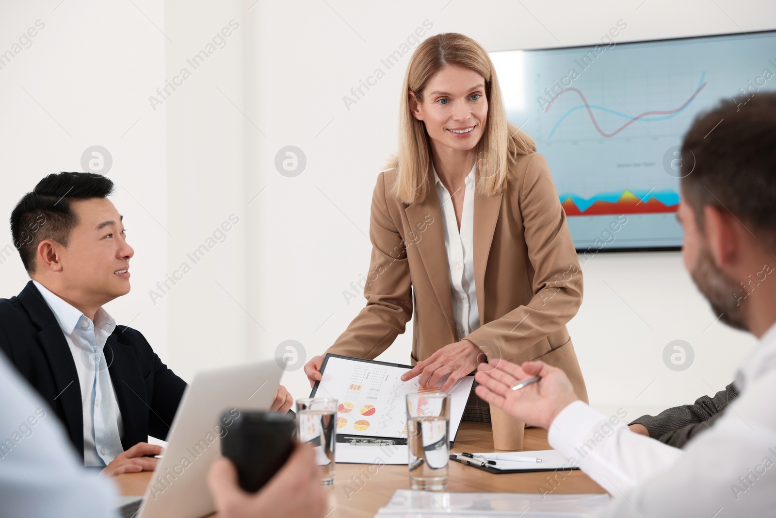 Photo of Businesswoman showing chart on meeting in office