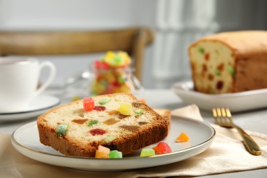 Delicious cake with candied fruits on table