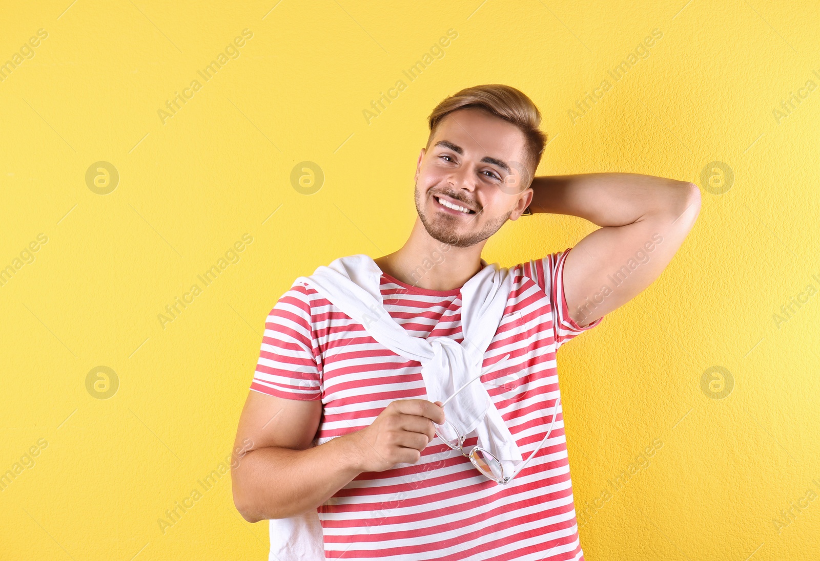 Photo of Young man with trendy hairstyle on color background