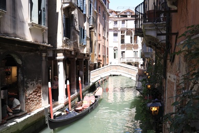 VENICE, ITALY - JUNE 13, 2019: Gondola on city canal. Gondola is traditional Venetian rowing boat