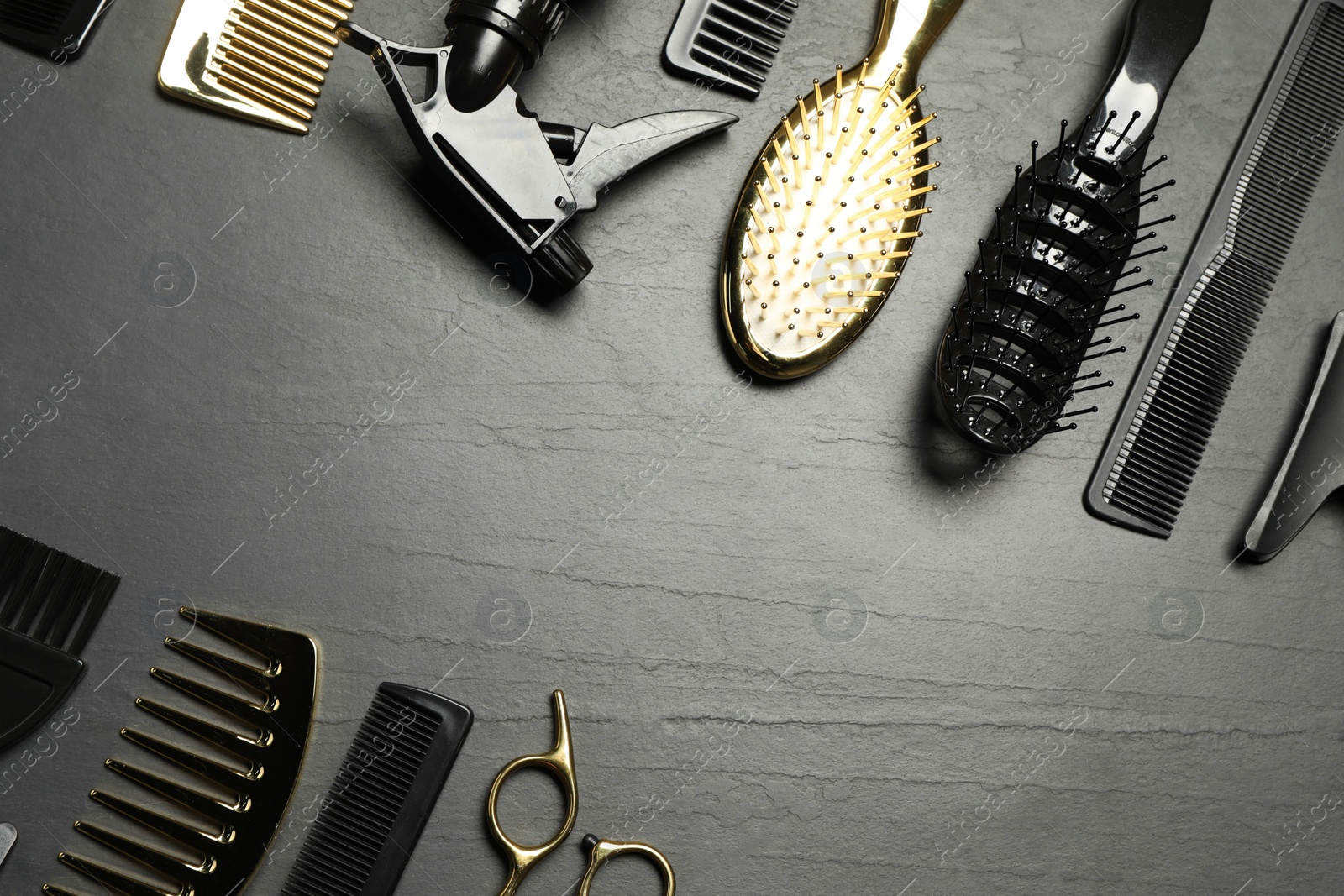 Photo of Hairdressing tools on grey textured background, flat lay. Space for text