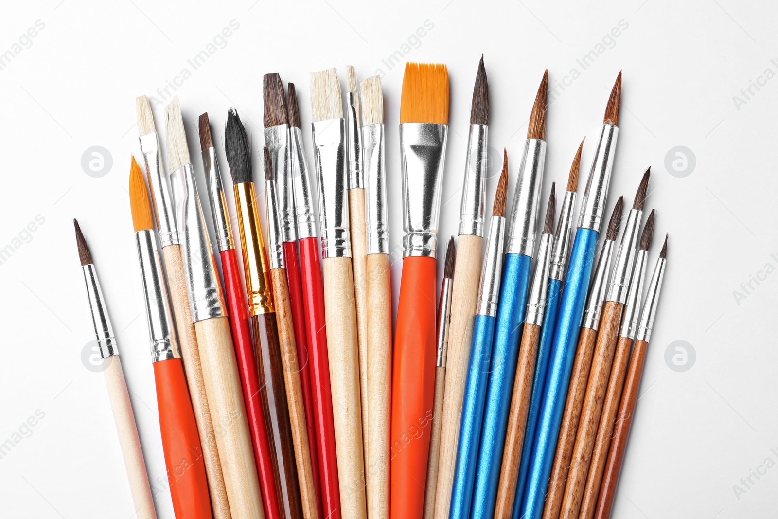 Photo of Different paint brushes on white background, top view