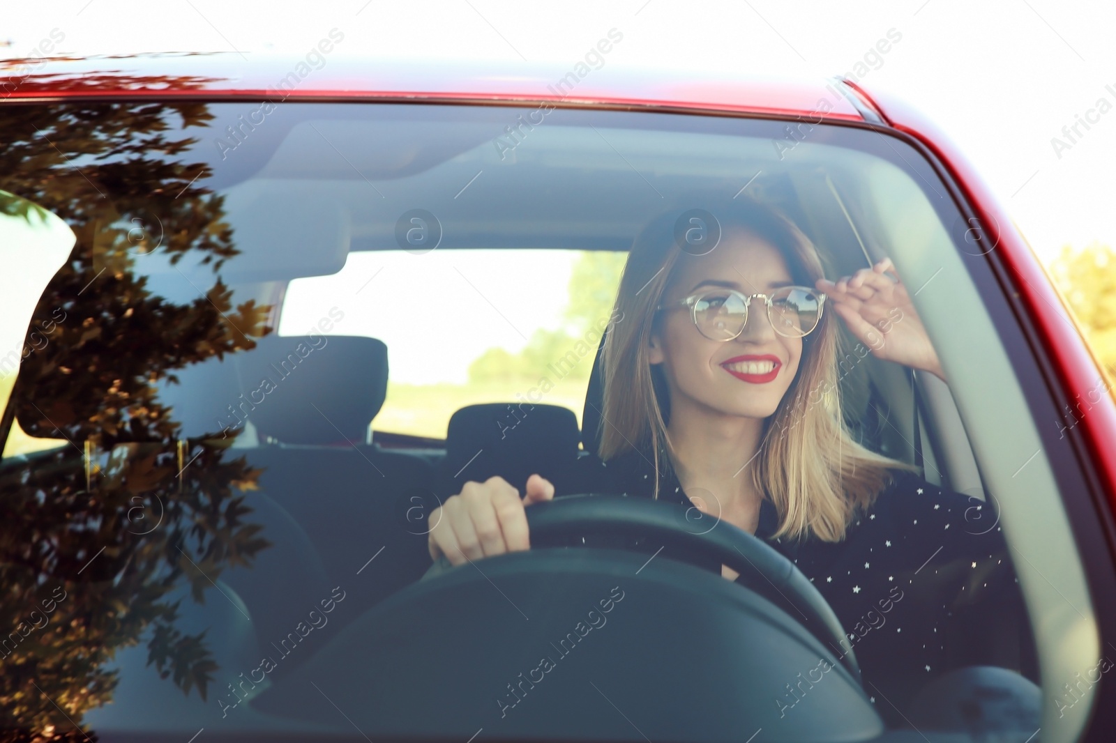 Photo of Young woman on driver's seat of car