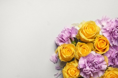 Beautiful blooming flowers on grey background, top view