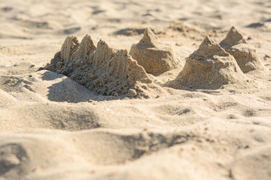 Photo of Beach with sand castle on sunny day