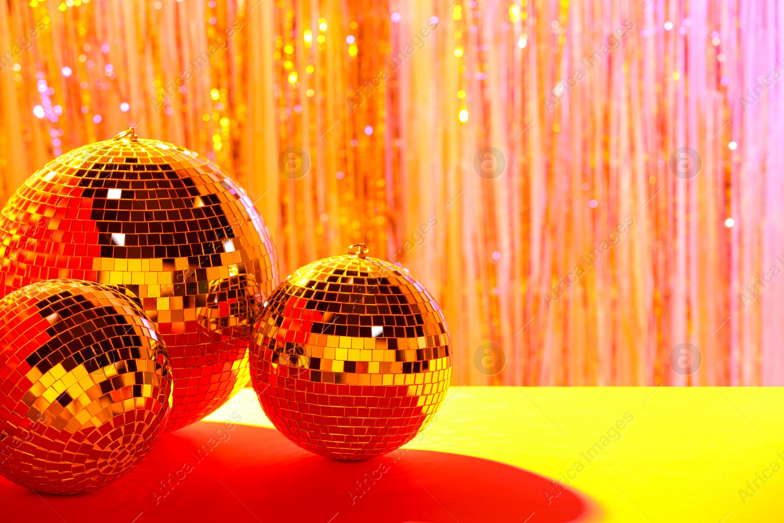 Photo of Shiny disco balls on blurred background, color toned. Space for text