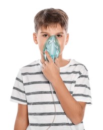 Boy using nebulizer for inhalation on white background