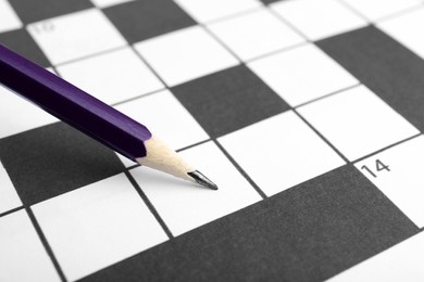 Photo of Pencil and blank crossword, closeup view. Space for text