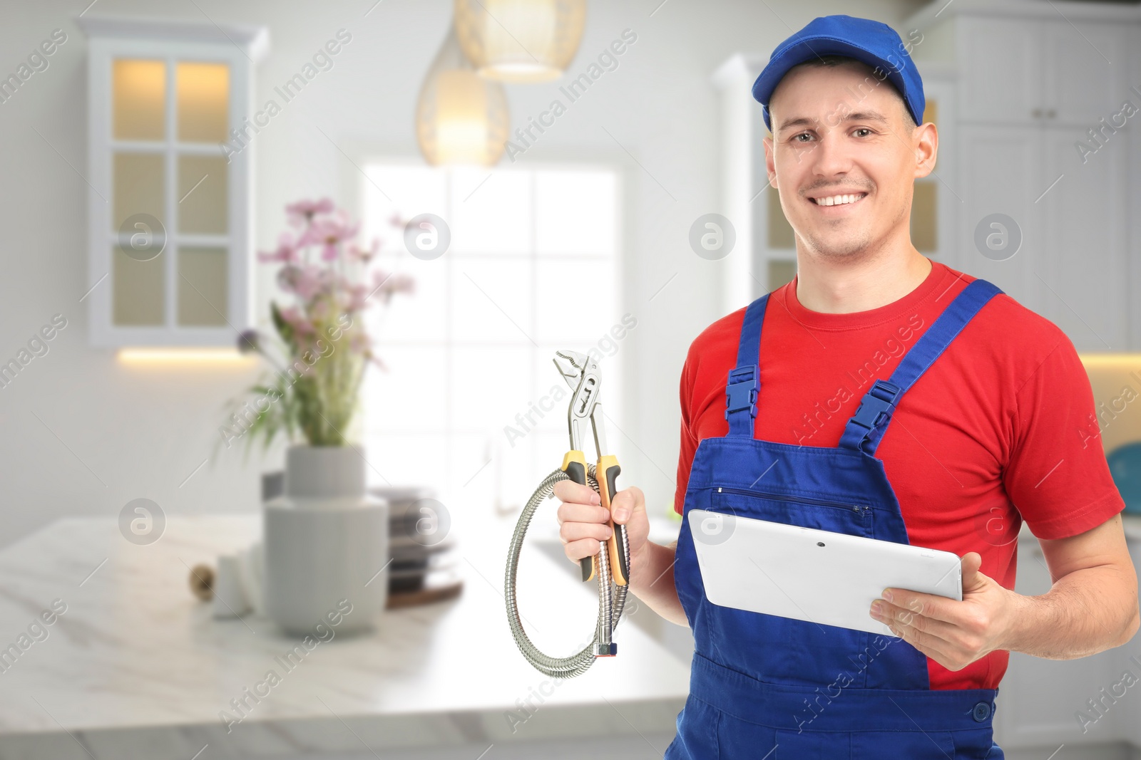 Image of Young plumber with tablet in kitchen, space for text