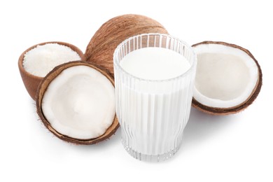 Photo of Glass of delicious vegan milk, coconuts and flakes on white background