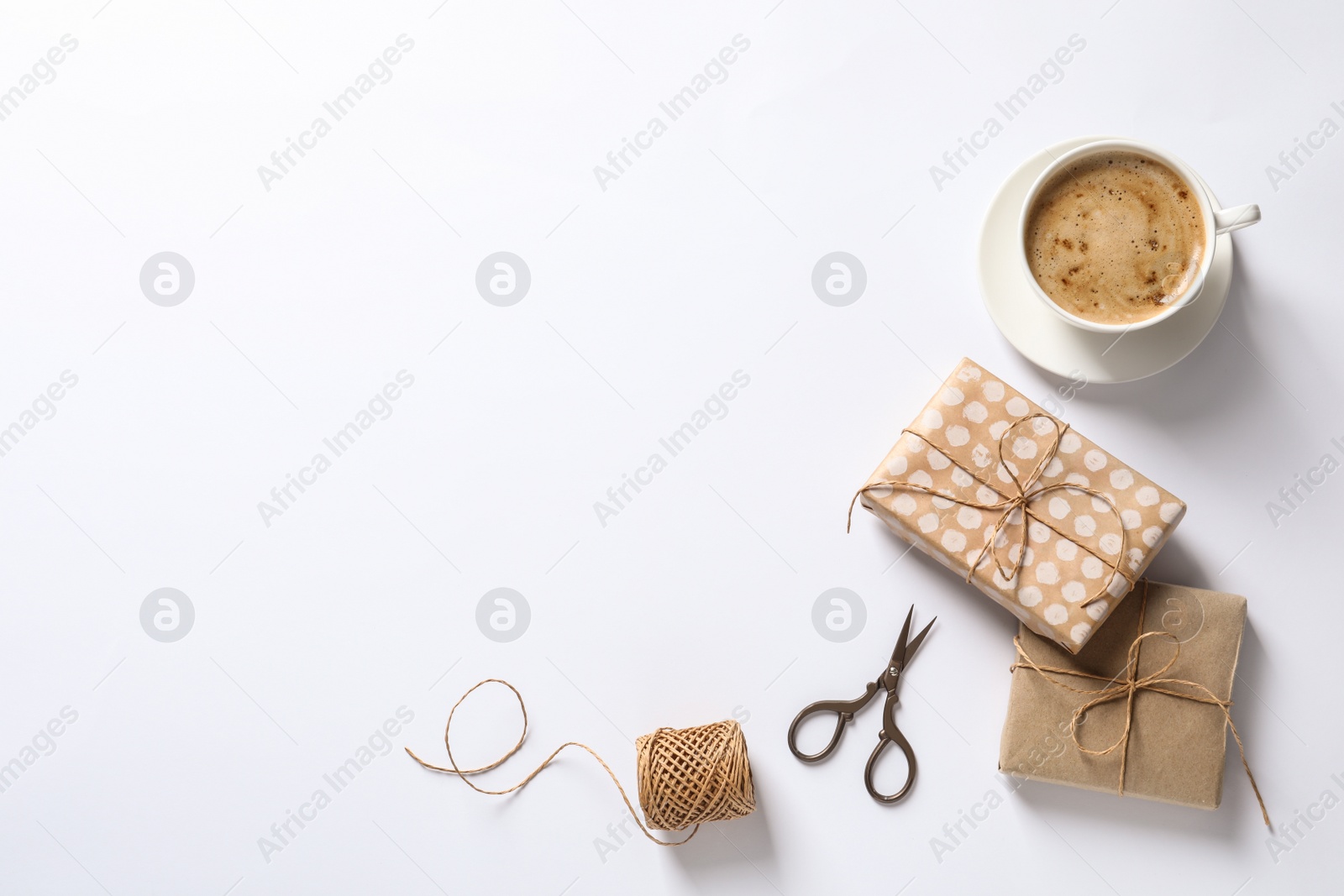 Photo of Composition with scissors, gifts and coffee on white background, top view