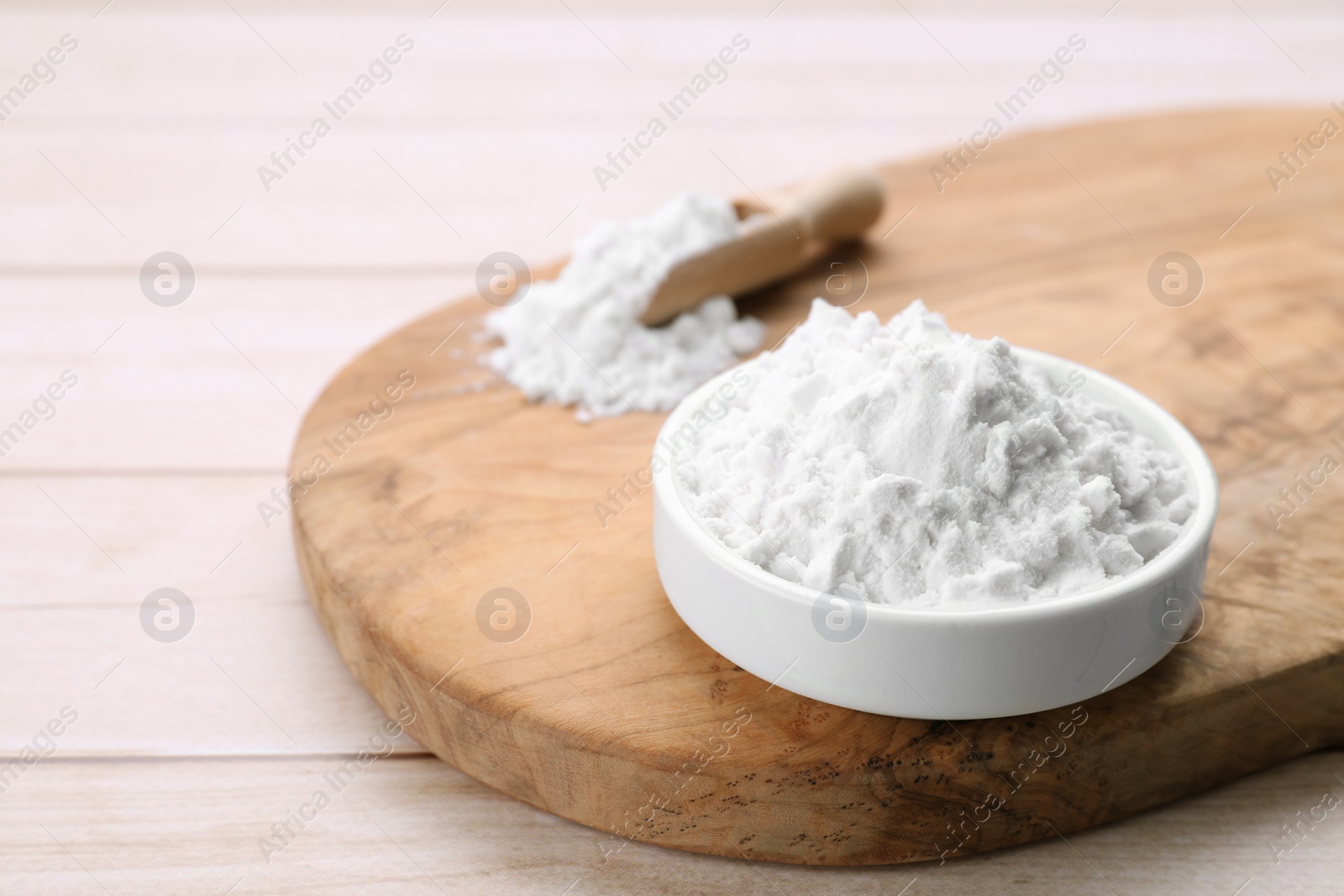 Photo of Starch in bowl on wooden table, closeup. Space for text