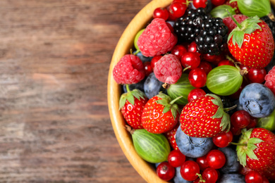 Photo of Mix of ripe berries on wooden table, top view