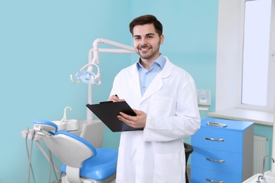 Photo of Portrait of male dentist in modern clinic