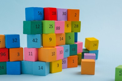 Photo of Wooden cubes with different numbers on light background