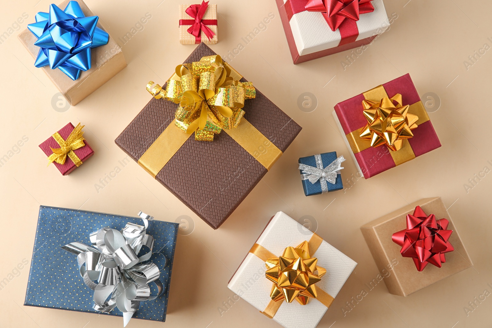 Photo of Flat lay composition with beautiful gift boxes on beige background