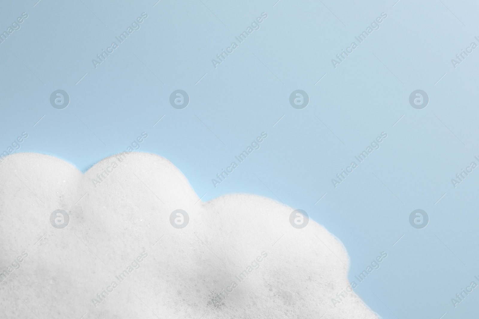 Photo of Foam sample on light blue background, top view. Space for text