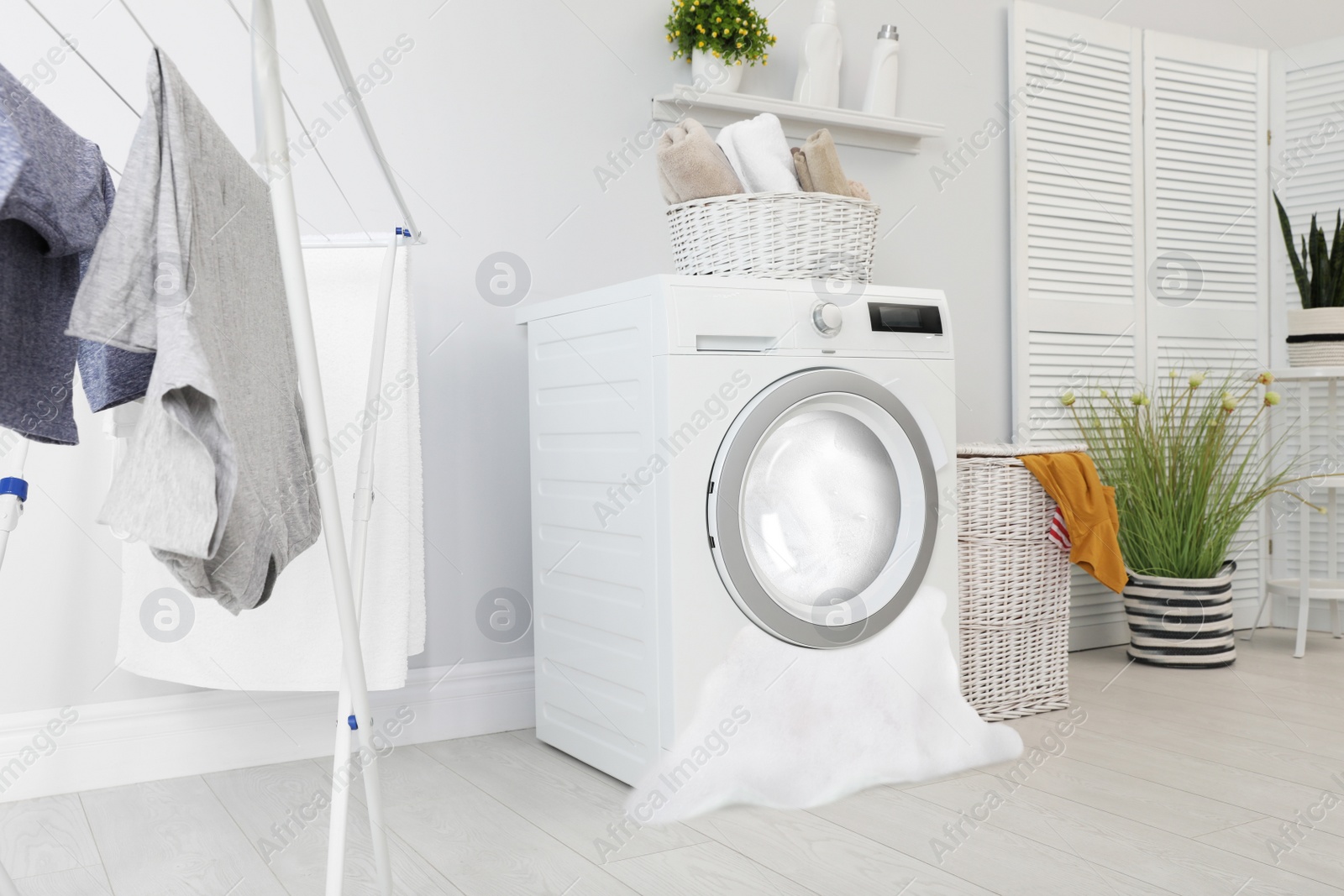 Image of Foam coming out from broken washing machine during laundering in room