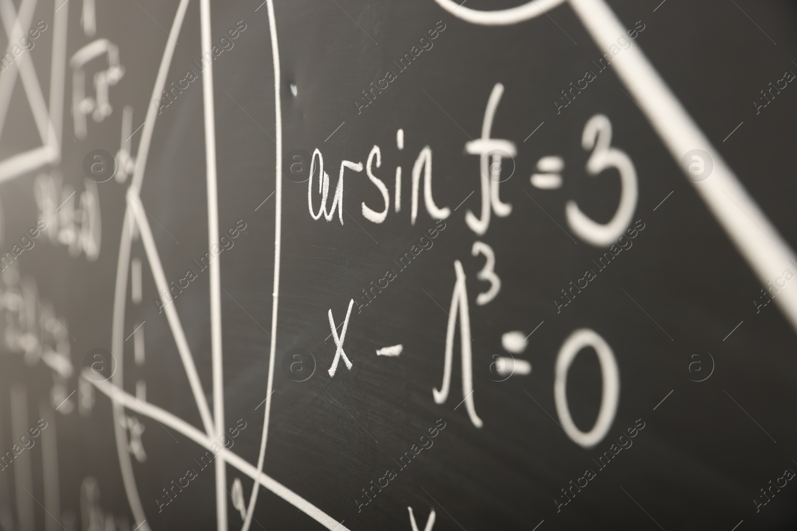 Photo of Mathematical formulas written with chalk on blackboard, closeup