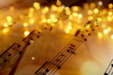 Image of Sheet with music notes as background, closeup. Christmas songs