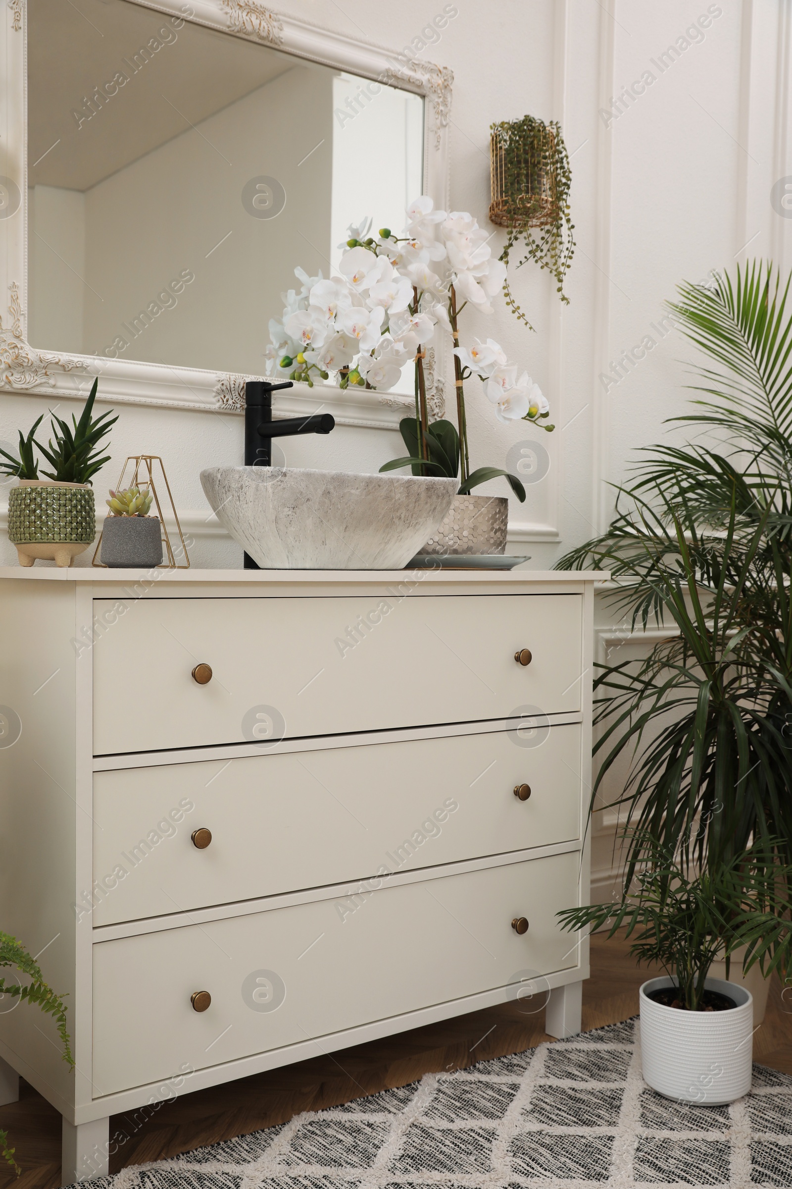 Photo of Stylish bathroom interior with modern furniture and beautiful houseplants