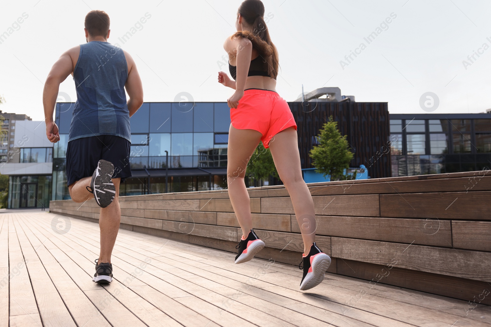 Photo of Healthy lifestyle. Couple running outdoors, low angle view