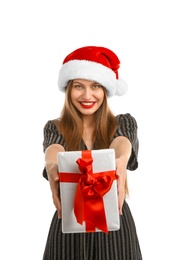 Young beautiful woman in Santa hat with gift box on white background. Christmas celebration