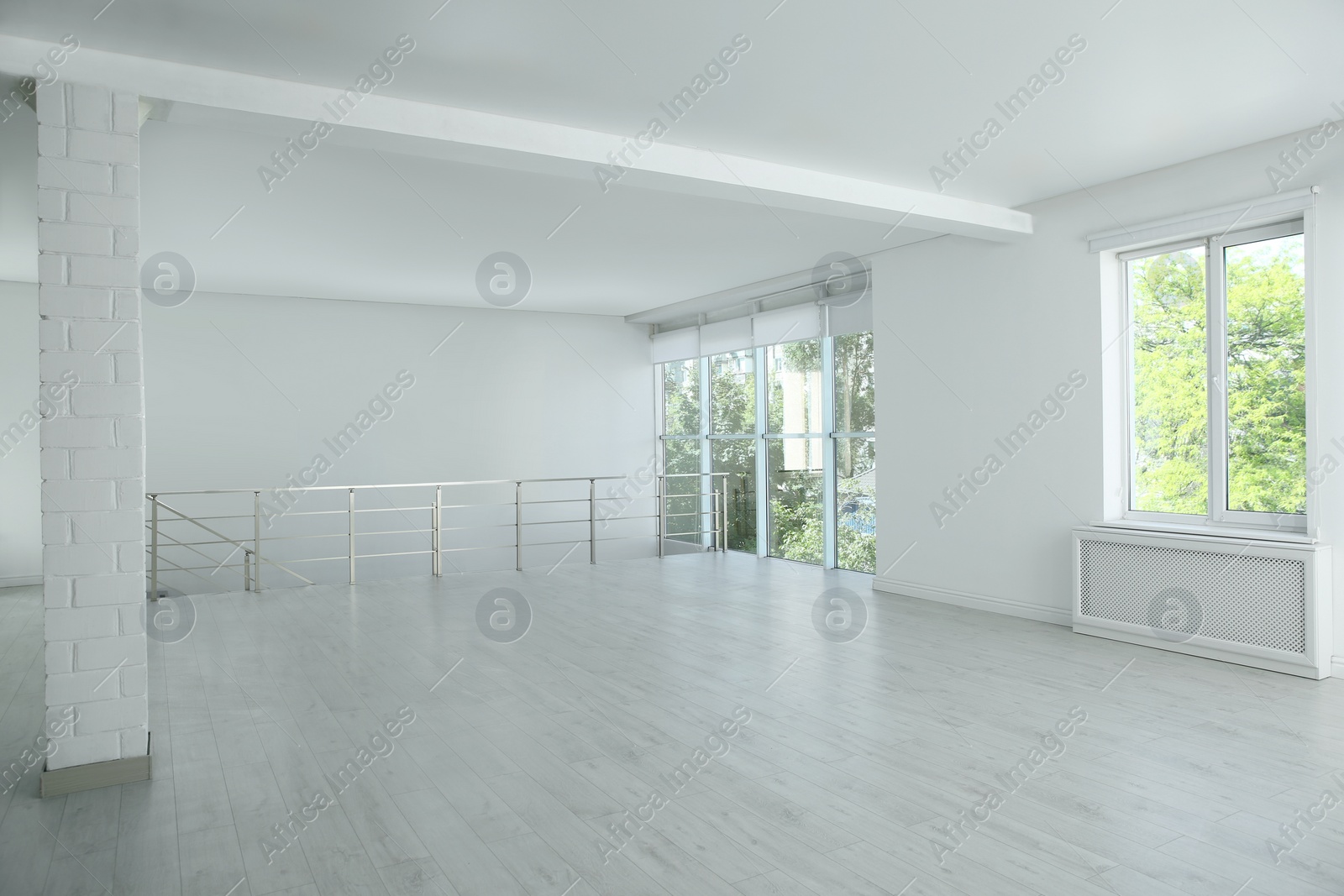 Photo of Large empty hall with windows and railings