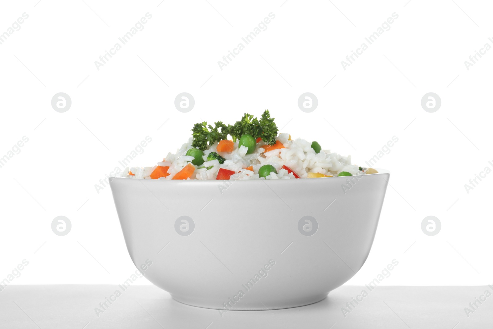 Photo of Bowl with tasty rice and vegetables on white background