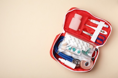 Photo of First aid kit on color background, top view with space for text